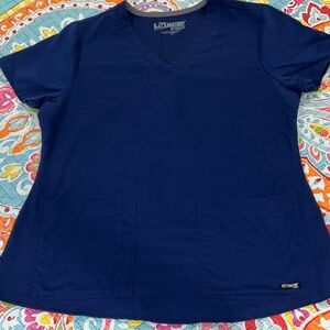 Barco Uniforms Navy V-Neck Short Sleeve Top. Medium Tall pants with a slit.